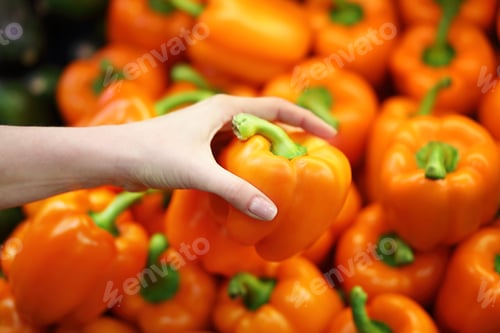Preview: Female Hand Chooses Pepper In The Store