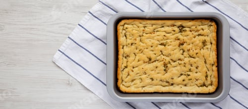 Preview: Home-baked Rosemary Garlic Focaccia Bread, top view. Flat lay, overhead, from above. Space for text.
