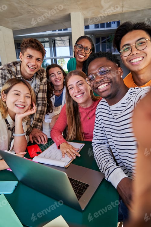 Preview: Group of multiracial students taking a selfie while gathering to study together at campus university
