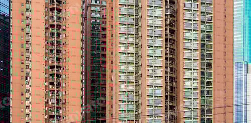 Preview: Tall residential building with balcony and glass window next to a glass commercial building