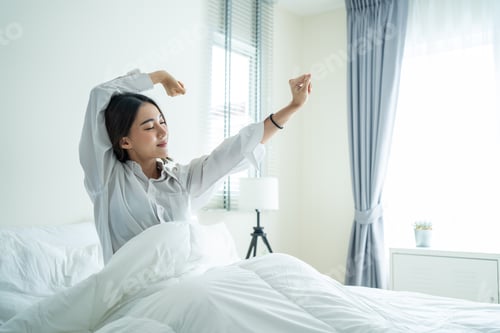Preview: Asian beautiful girl in pajamas wake up in the morning with happiness.