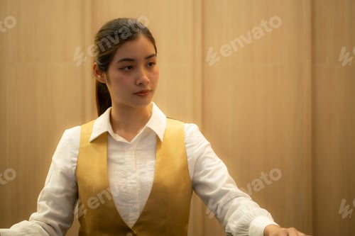 Preview: Asian ticket seller at the box office with the service of selling movie tickets to movie audiences