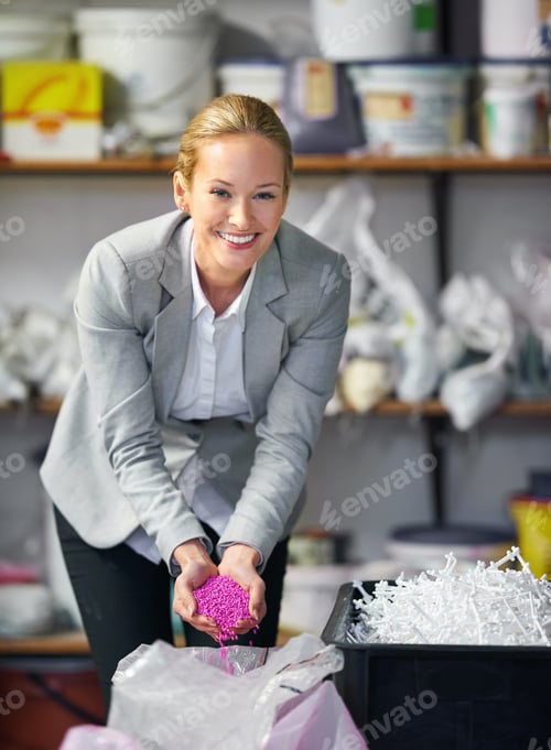 Smiling Woman Holds Pink Pellets in Workplace Setting