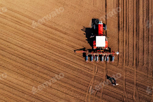 Preview: Aerial view of farmer and tractor with crop seeder