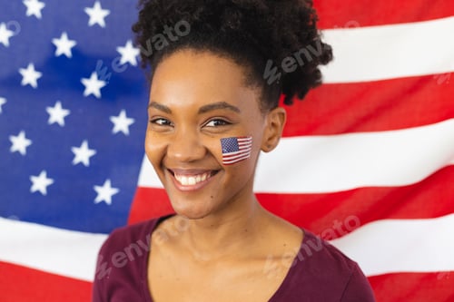Preview: Image of happy african american woman with flags of usa on face over flag of usa