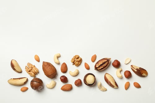 Preview: Different tasty nuts on white background, space for text