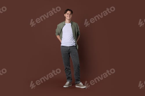Preview: Man in stylish jeans on brown background