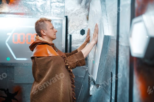 Preview: Man Wearing Futuristic Brown Garb Interacts with Interface