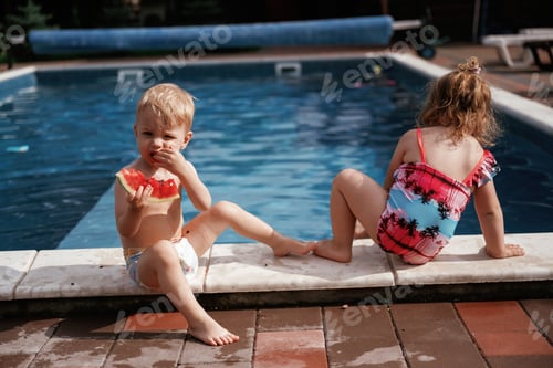 Preview: Eating tasty watermelon. Boy and girl are having fun by the pool