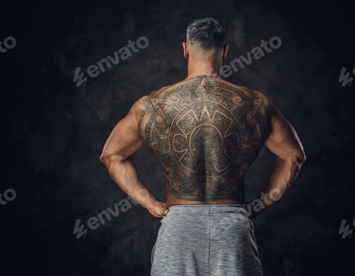 Preview: Adult caucasian muscular bodybuilder in a studio