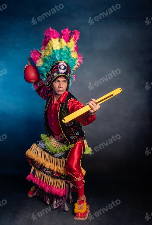 Preview: Matlachines Dancer from Coahuila Mexico A man in a colorful costume holding a drum and a ball
