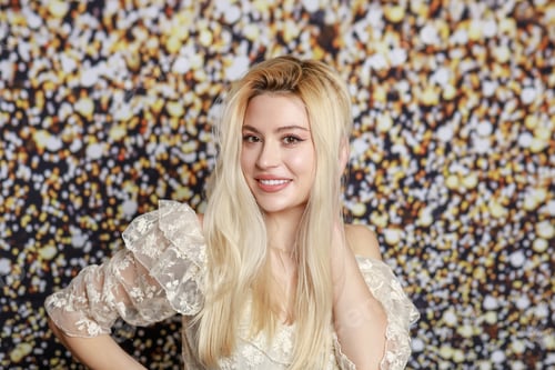 Preview: Adorable blonde standing on gilded background and looking at the camera