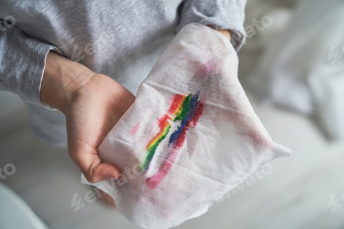 Preview: Faceless boy with wet wipe painted with rainbow