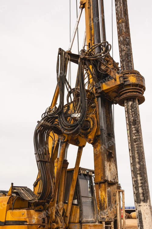 Preview: large construction machinery on a truck in a lot with trees