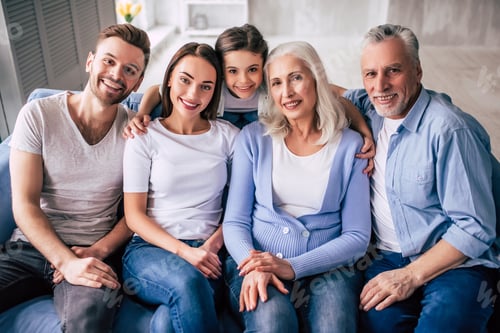 Preview: The happy multi generation family sitting on the sofa.