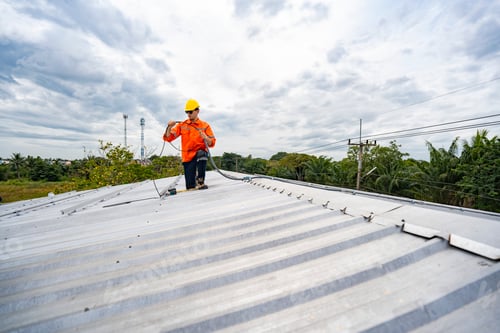 Preview: A skilled technician adjusts a solar panel on rooftop