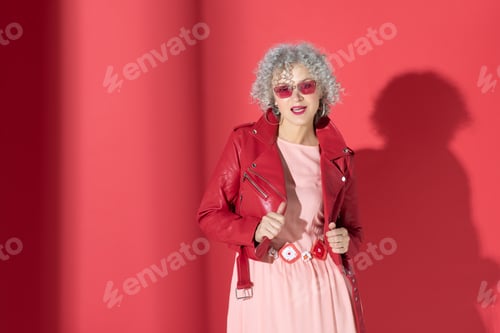 Preview: Stylish mature woman wearing red leather jacket