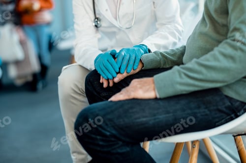 Preview: Unrecognizable doctor consoling senior patient at hospital waiting room.