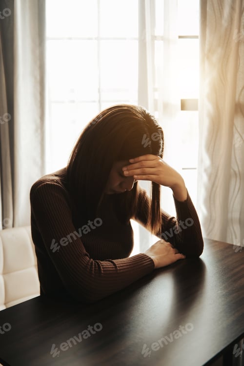 Preview: Asian woman sit Depression Standing by window and anxiety Copy space.