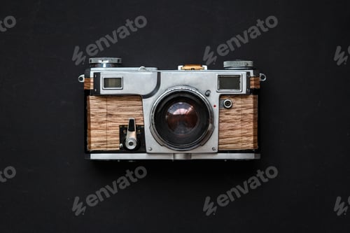 Preview: Old analog photo camera with wooden body on black background