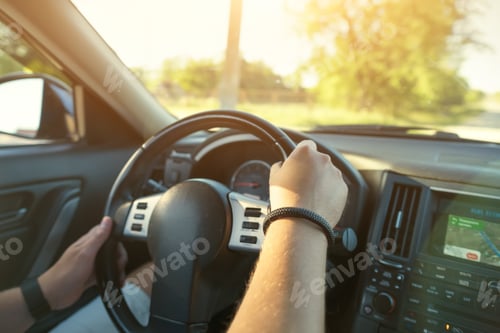 Preview: Driver's hands and car dashboard.