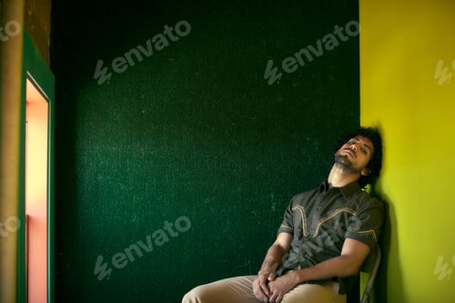 Preview: Portrait of mid adult man sitting on chair