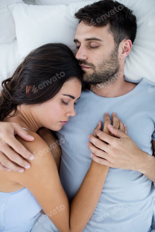 Preview: Young romantic couple sleeping on bed