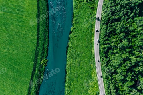 Preview: Aerial drone view of road with cars, blue river and green fields and woods.