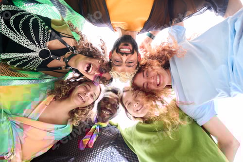 Preview: A group of people are standing in a circle with their heads together