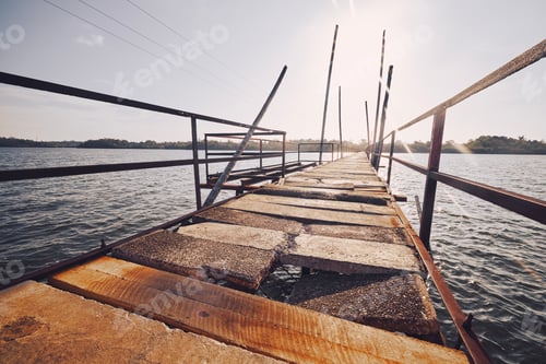 Preview: Old damaged bridge over lake