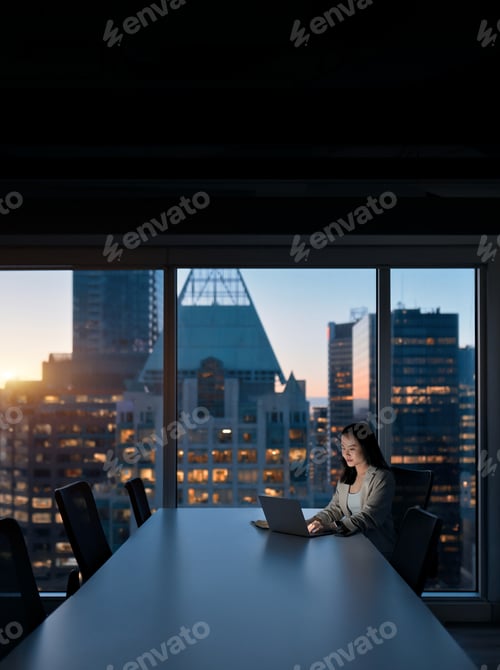 Preview: Young busy Asian business woman working on laptop at night in office.