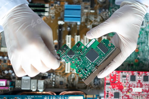 Preview: the scientist hands in gloves work with a circuit board in laboratory, close up view