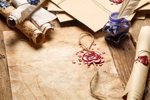 Preview: Closeup of old rolls of paper, glasses and blue ink in the inkwell