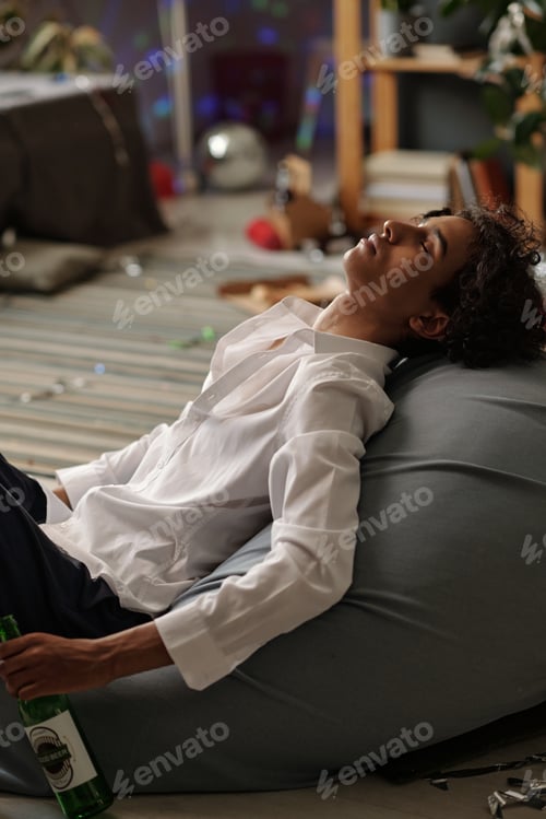 Preview: Young asleep man with empty bottle