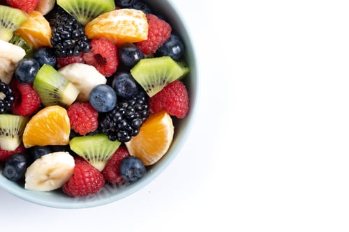 Preview: Fruit salad in a blue bowl isolated on white background