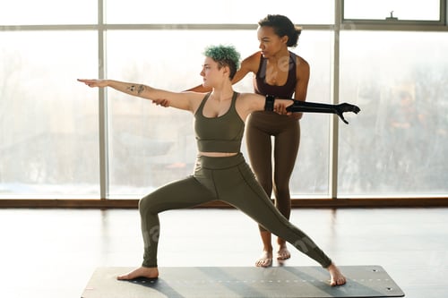 Preview: Woman doing stretching exercises with instructor