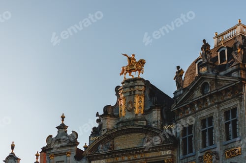 Preview: low angle view of statues on antique buildings in brussels, belgium