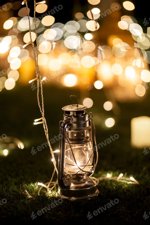Preview: burning candles on a dark night in a wooden lantern