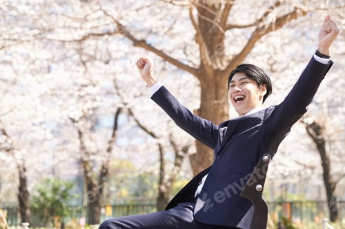Preview: Japanese male businessman doing a banzai.