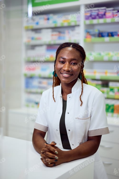 Preview: Smiling Female Pharmacist in Store with Shelves of Medicines in the Background