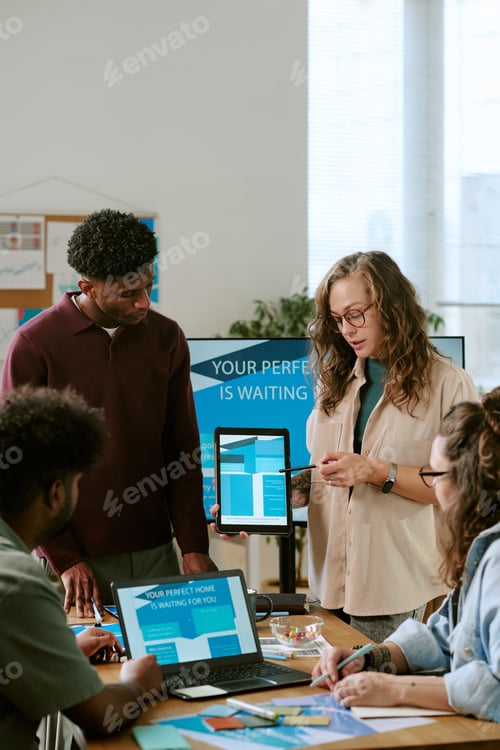 Preview: Young Caucasian Woman Presenting Digital Marketing Strategy to Diverse Team