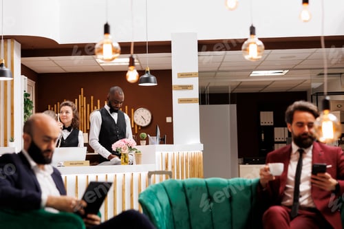 Preview: Diverse hotel staff works at front desk