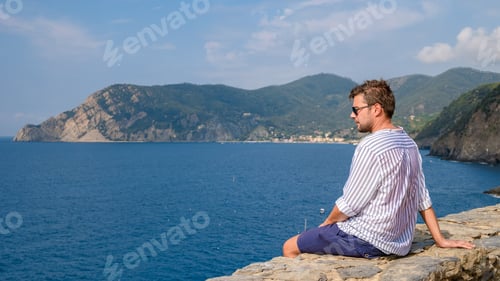 Preview: Young caucasian men visiting Riomaggiore Cinque Terre wonderful Liguria Italy during summer vacation