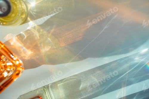 Preview: Face oil and perfume bottle reflections on white background