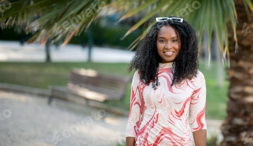 Preview: Portrait Of Smiling Beautiful Young African American Woman Posing Outdoors