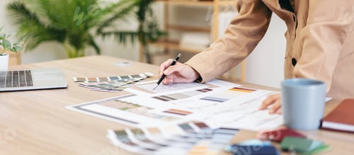 Preview: Woman architect working to sketching and designing building on blueprint while work about planning