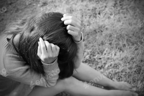 Preview: Sad woman she sitting on grass black and white photo flat lay.