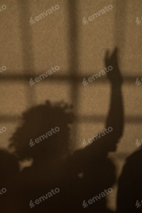 Preview: Shadow of a woman raising her arm
