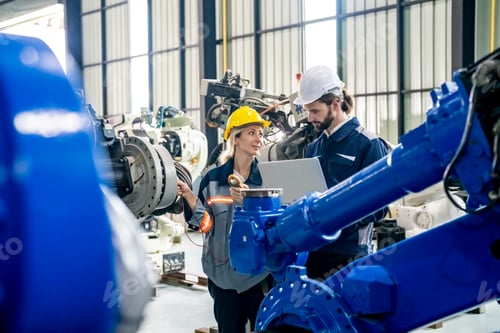 Preview: Engineer with robot in automotive parts factory