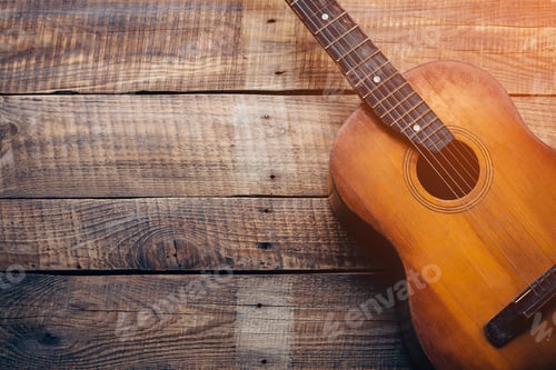 Preview: Wooden guitar. Close-up of guitar lying on vintage wood background